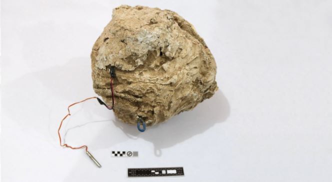 An Islamic State improvised explosive device disguised to look like a rock, top, is triggered by a passive infrared sensor. The militants produced weapons like this by the thousands.