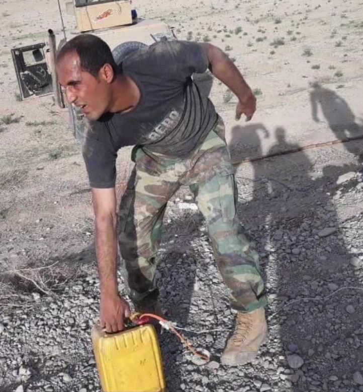 A company commander with 2nd Kandak, 3rd Brigade, Afghan National Army 215th Corps, personally disarms and disposes of a IED found in Yakhchal district, Helmand province, Afghanistan. (